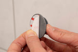 Mobile button with adhesive pad